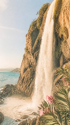towering waterfall cascading down a cliff