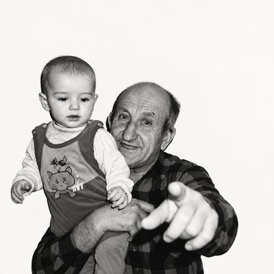 a man holding a baby in his arms
