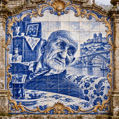 a blue and white tile mural of an elderly man