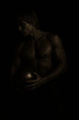 a black and white photo of a man holding a ball