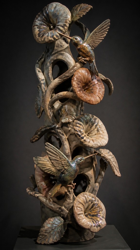 a climbing vine of flowers and hummingbirds on a dark background, tall wrapping composition, no text