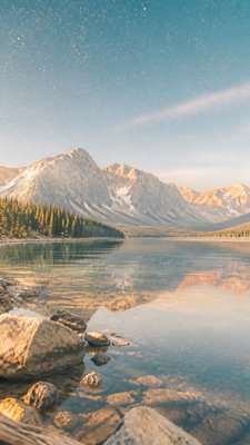 a tranquil mountain lake beneath a starry night sky, no people, no text