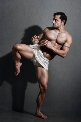 a man in a white underwear is doing a kickbox pose