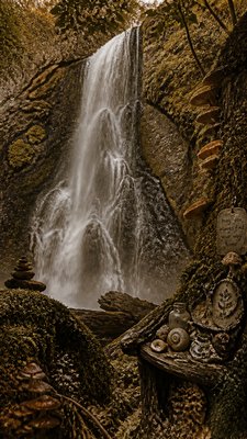 towering waterfall cascading down a cliff