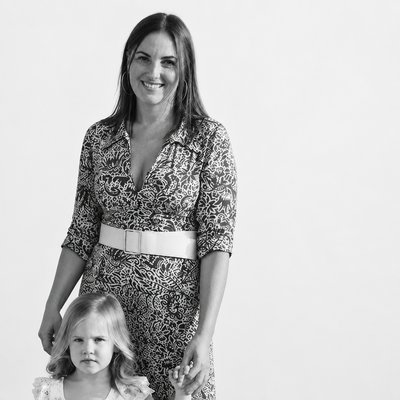 a woman and a little girl standing next to each other