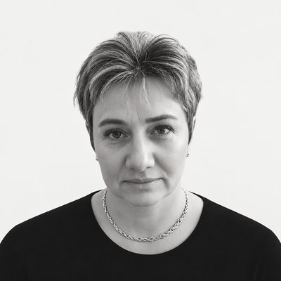 a black and white photo of a woman wearing a necklace