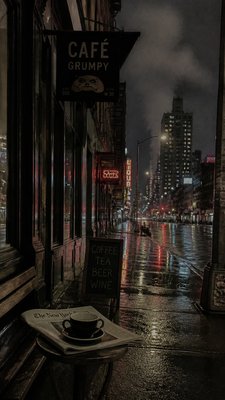 a quiet rainy city street at night reflecting neon signs, no people