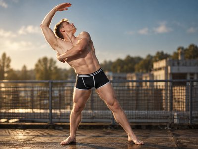 a man with no shirt is playing frisbee