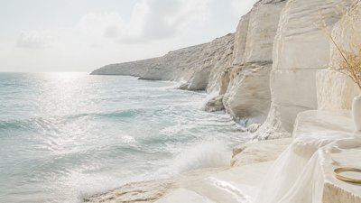 a moonlit coastline with cliffs and crashing surf, no people