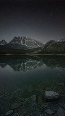 a tranquil mountain lake beneath a starry night sky, no people, no text
