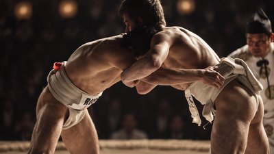 two sumo wrestlers facing each other in a ring
