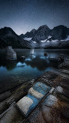 a tranquil mountain lake beneath a starry night sky, no people, no text