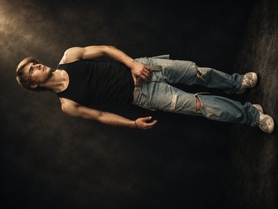 a man laying on the ground in a dark room