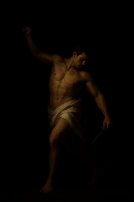 a man in a towel holding a knife