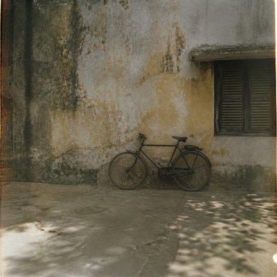 bicyle resting against a wall