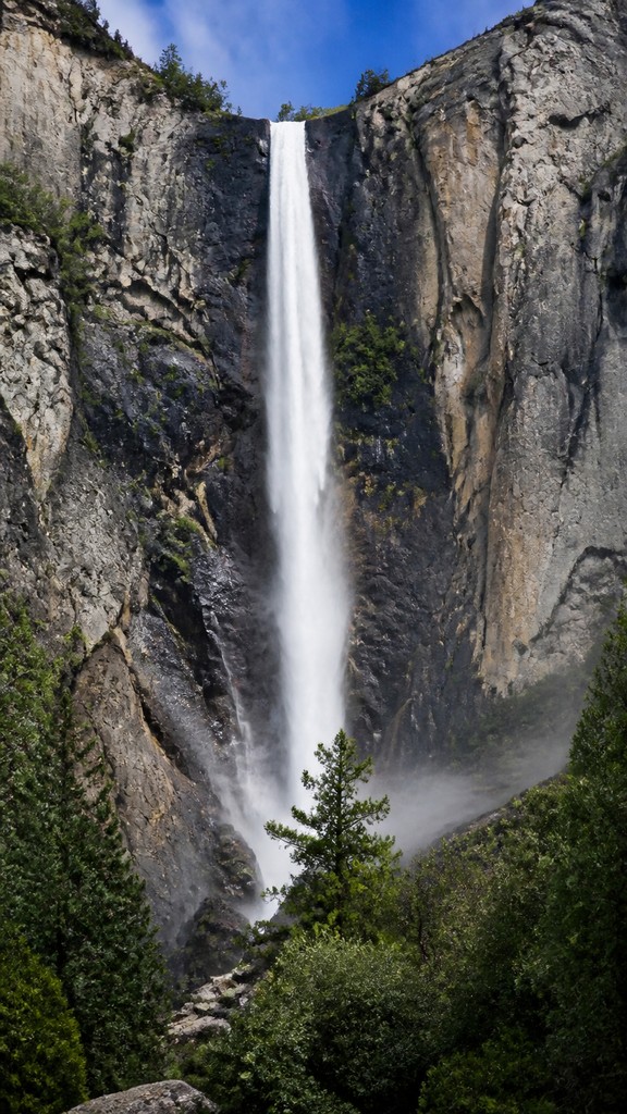 towering waterfall cascading down a cliff