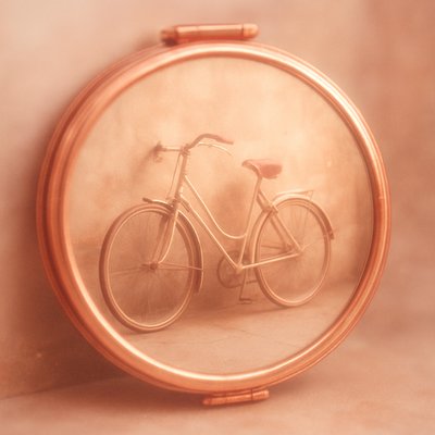 bicyle resting against a wall
