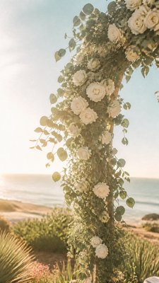 an arch of white roses and eucalyptus in soft morning light, elegant vertical composition with open space, no text