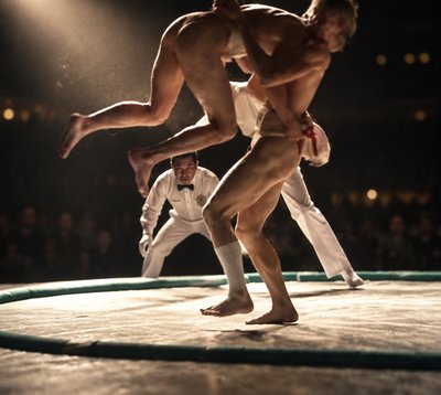 a couple of men standing on top of a wrestling ring