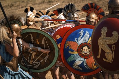 a group of men in roman armor and helmets