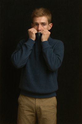 a man in a blue sweater covers his mouth with his hands