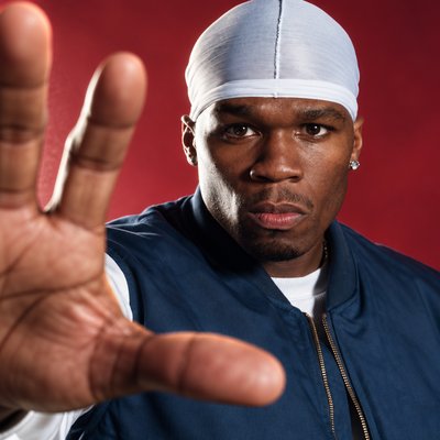 a man wearing a white headband making a hand gesture
