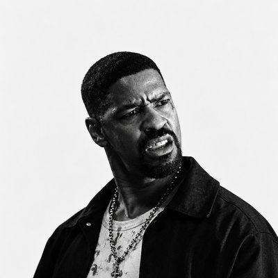a black and white photo of a man wearing a necklace