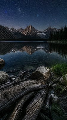 a tranquil mountain lake beneath a starry night sky, no people, no text