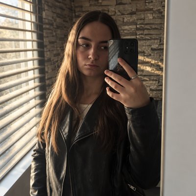 a woman taking a picture of herself in a mirror