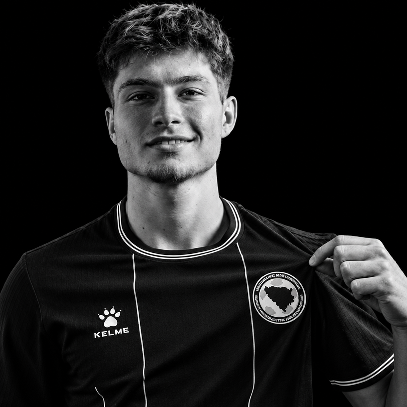 a black and white photo of a man holding a soccer jersey
