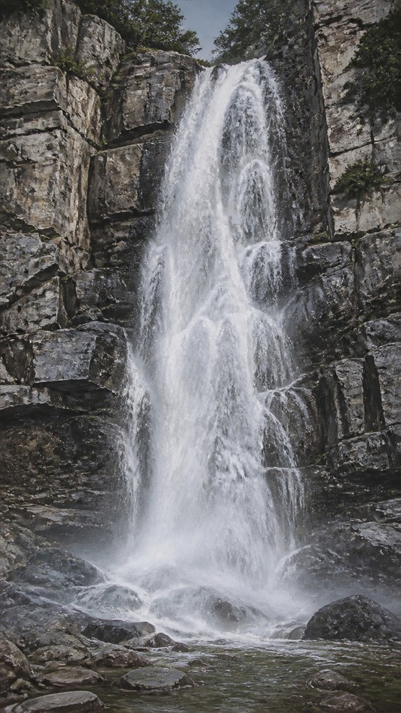 towering waterfall cascading down a cliff