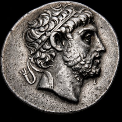 a silver coin with a man's head on it