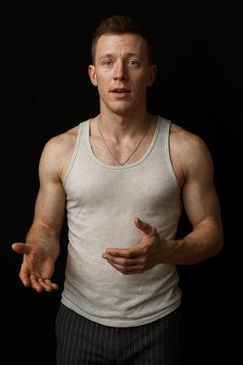 a man in a tank top holding his hands out