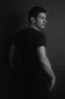 a black and white photo of a man in a dark room