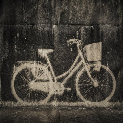 bicyle resting against a wall