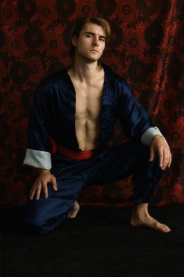 a man with no shirt sitting on the ground