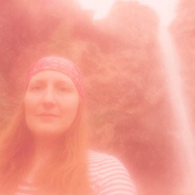 a woman with red hair wearing a headband