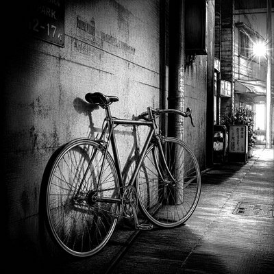 bicyle resting against a wall