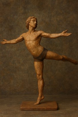 a wooden statue of a man doing a yoga pose