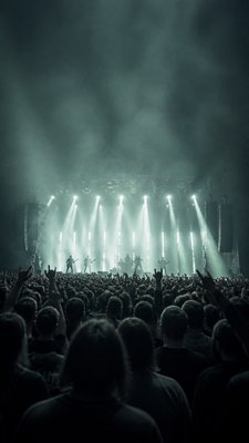 a live music scene with a glowing stage and silhouetted crowd, energetic vertical composition with open space at the top, no text