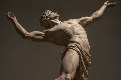 ancient greek athlete bending his back and raising his arms