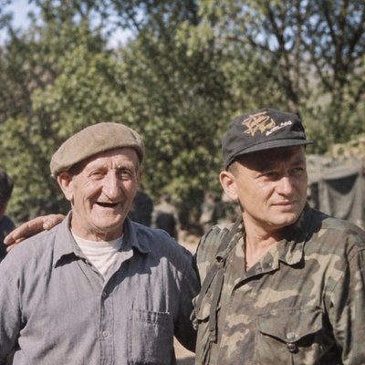 a couple of men standing next to each other
