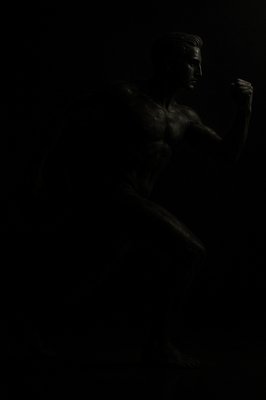 a black and white photo of a man in the dark