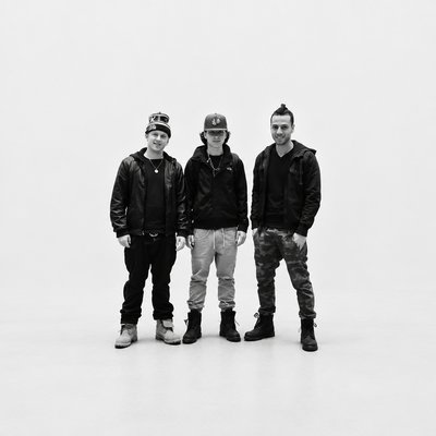 a group of three men standing next to each other
