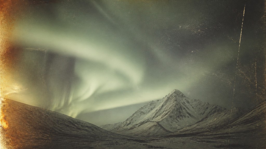 a flowing aurora over snowy peaks, wide sweeping composition, no people, no text