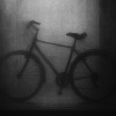 bicyle resting against a wall