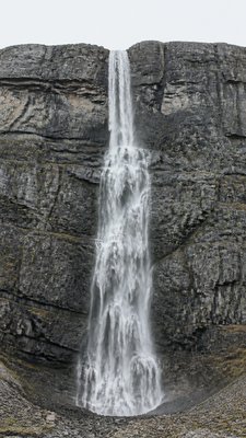 towering waterfall cascading down a cliff