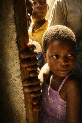 a little girl standing next to a group of people