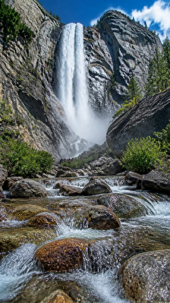 towering waterfall cascading down a cliff