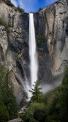 towering waterfall cascading down a cliff
